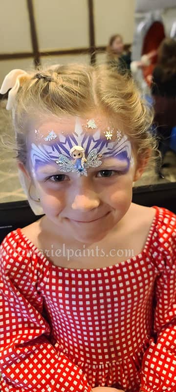 A girl with Frozen themed airbrush face paint