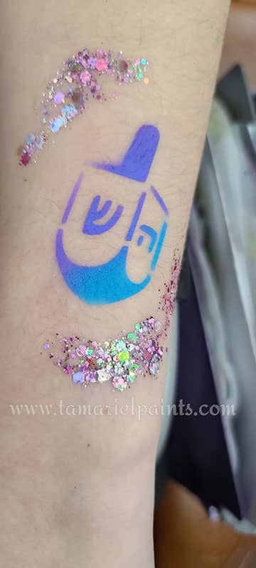 Airbrush design of a colorful dreidel design with sparkles