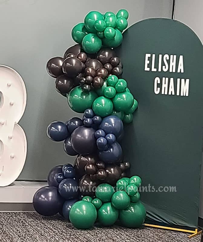 Green and black balloons in creative display at entrance