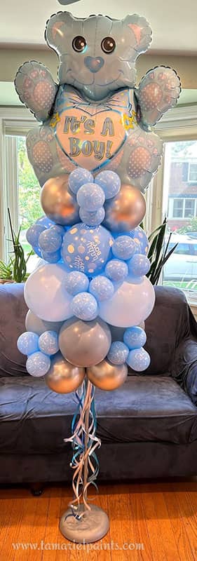 Blue and silver balloon display with balloon teddy bear announcing the birth of a boy