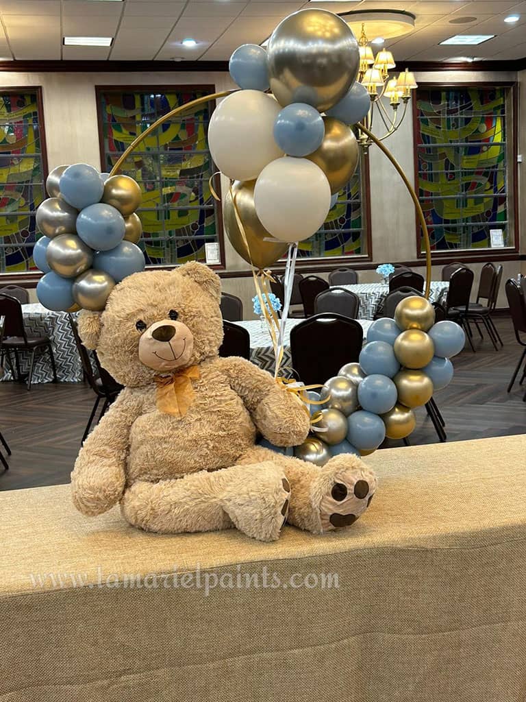 A creative balloon display with white, light blue and sliver balloons