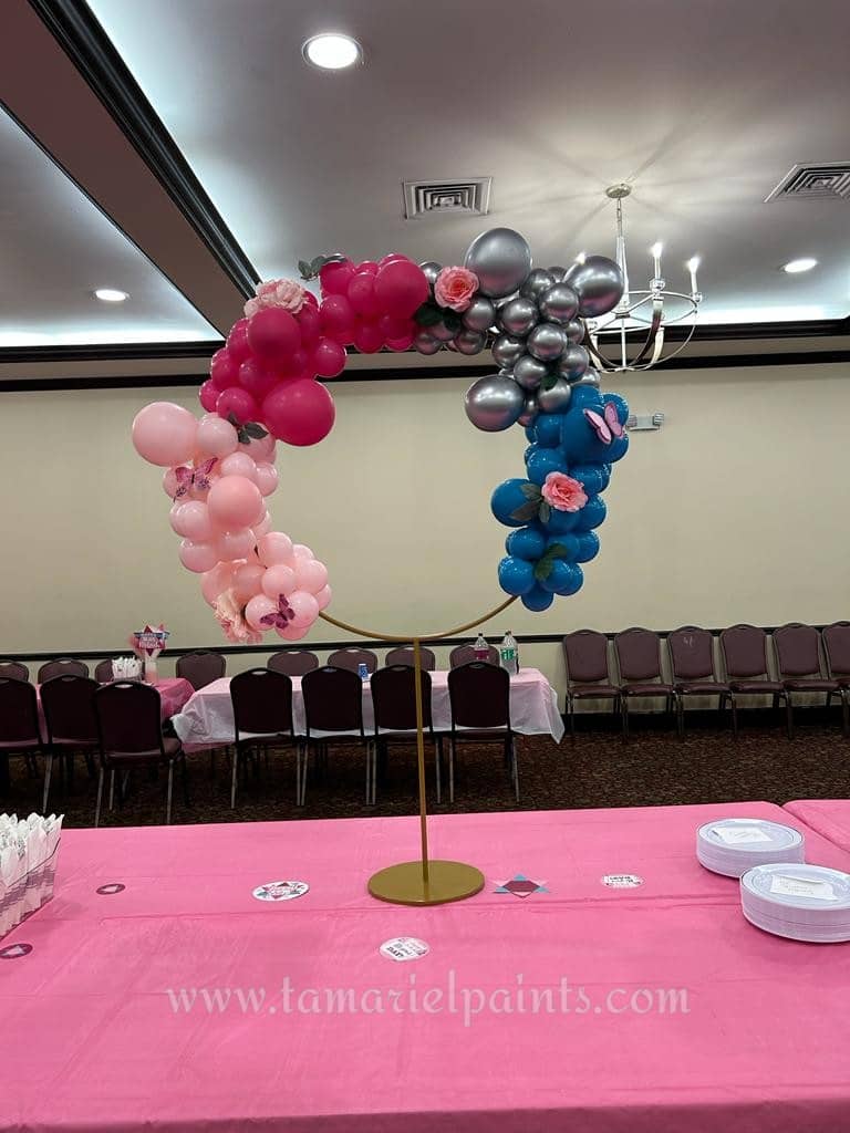 Circular table balloon display with pink, red, silver and blue balloons