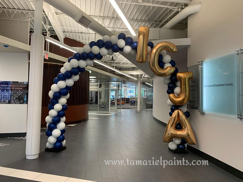 A photo of a balloon arch display in a corporate office