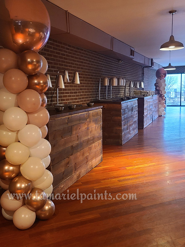 A photo of 2 columns of balloons at a corporate event