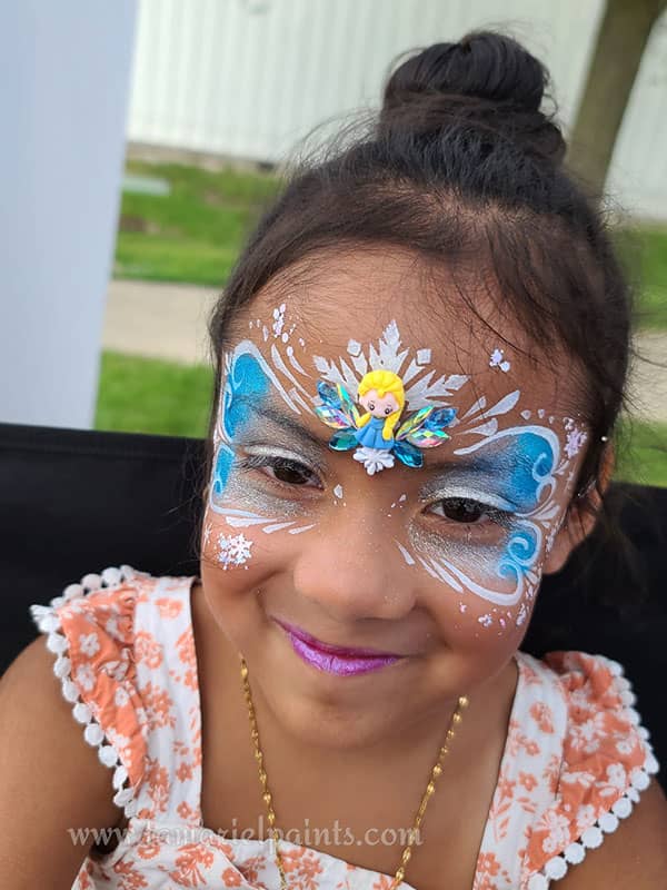 A girl with colorful Frozen themed face paint