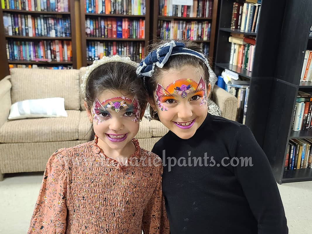 Two girls with colorful face paint