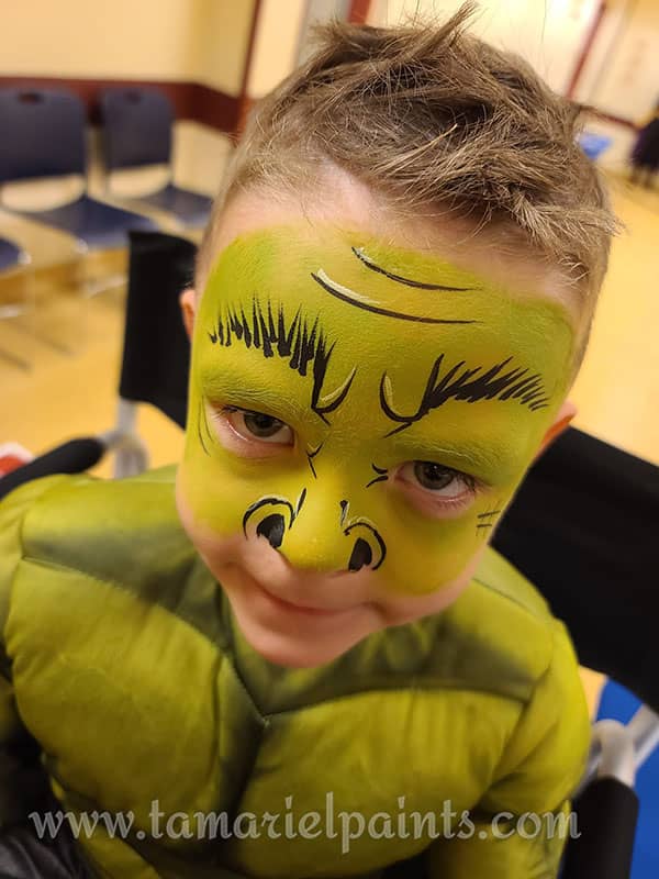 A boy with green face paint