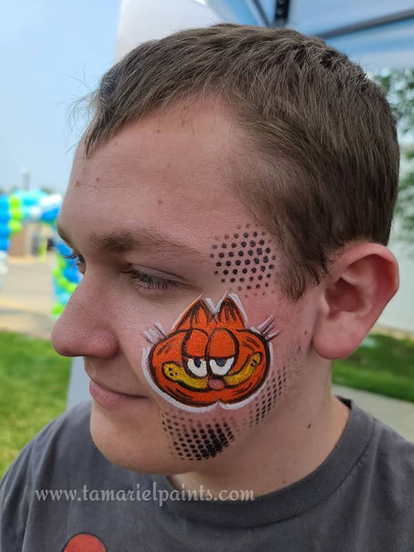 A person with Garfield themed face paint