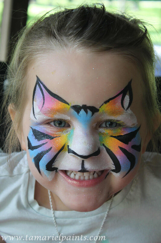 A girl with colorful tiger face paint