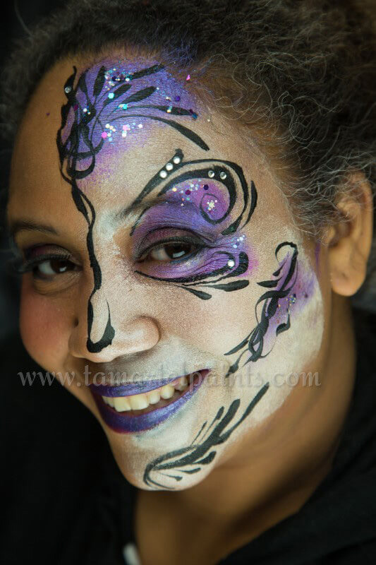 A woman with colorful flower face paint