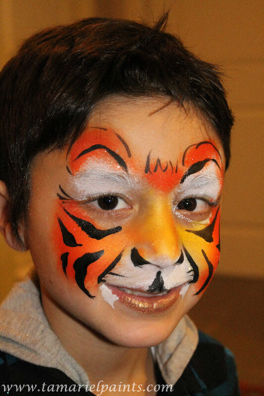 A boy with tiger face paint