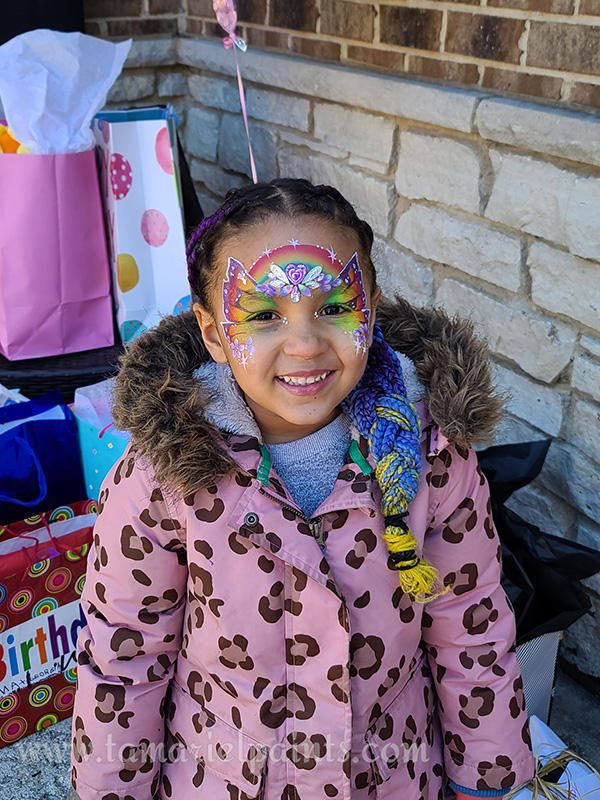 A girl with rainbow flower face paint