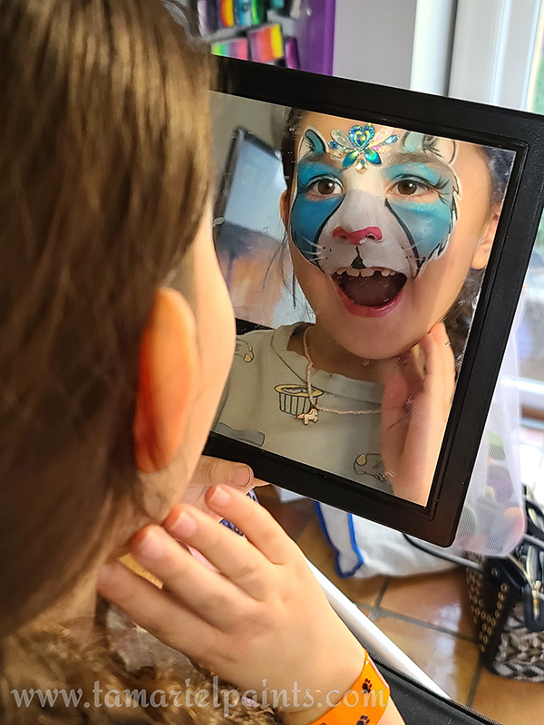 A girl with animal face paint