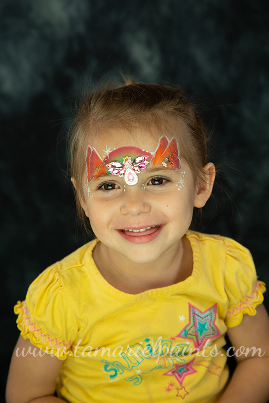 A girl with colorful face paint