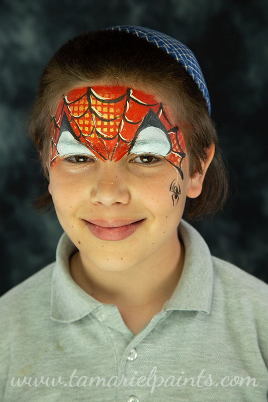 A boy with Spiderman themed face paint