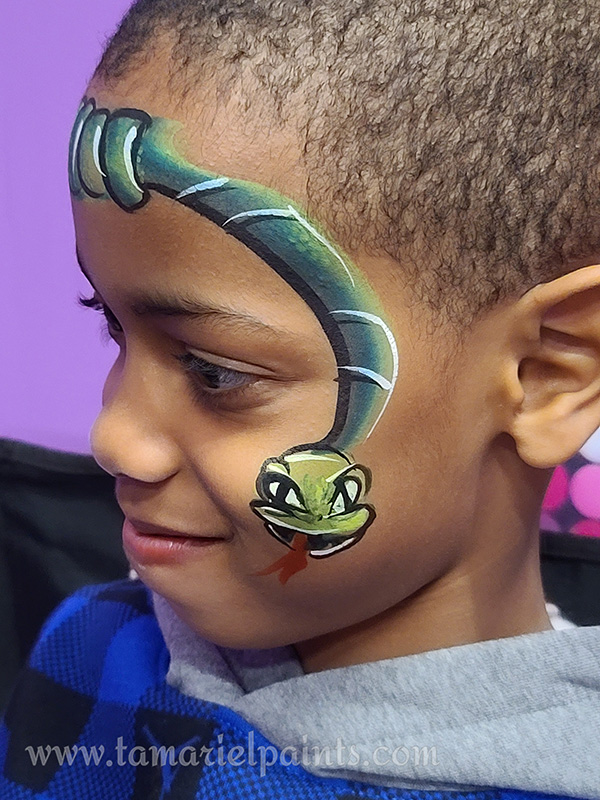 A boy with snake face paint