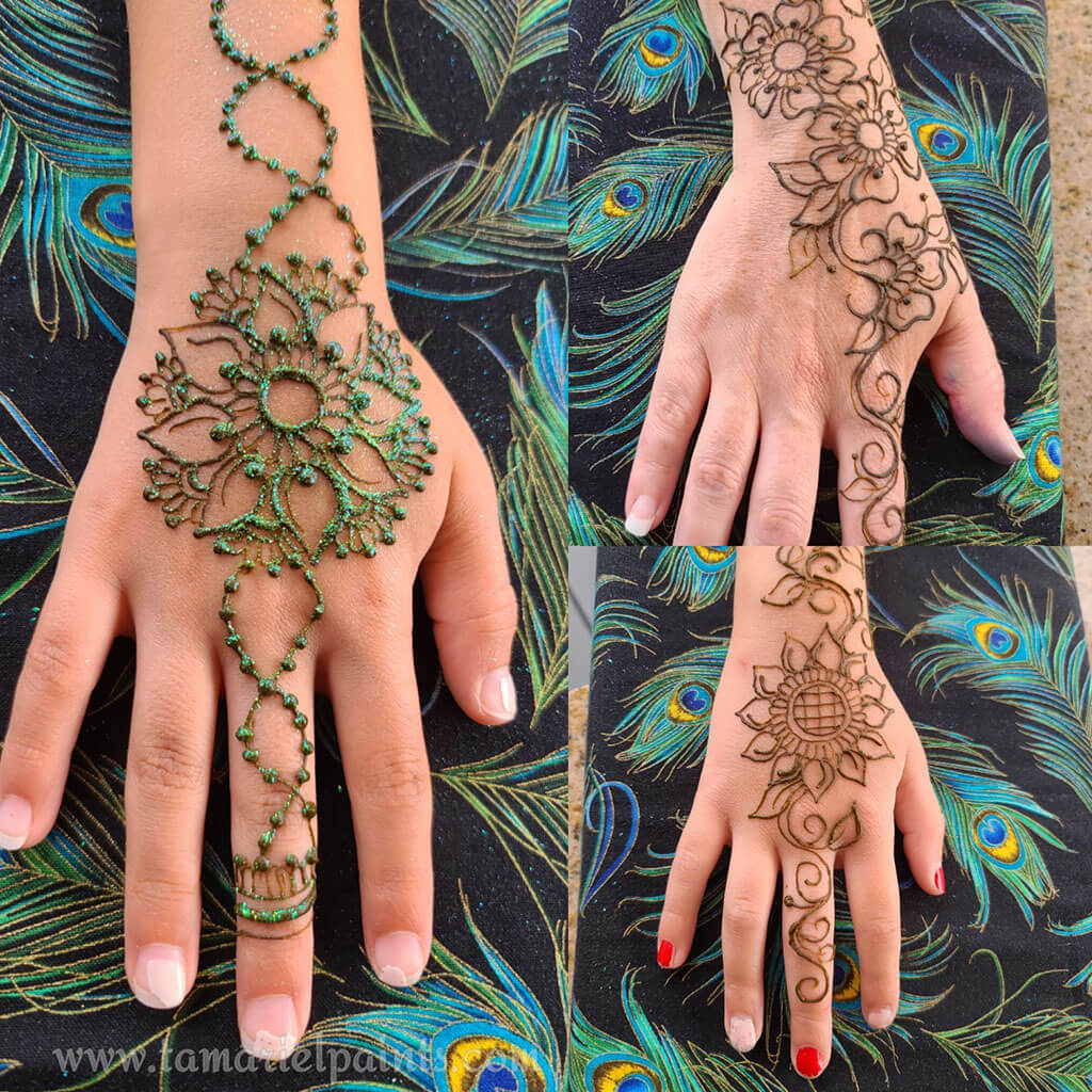 A hand with an intricate floral henna tattoo pattern