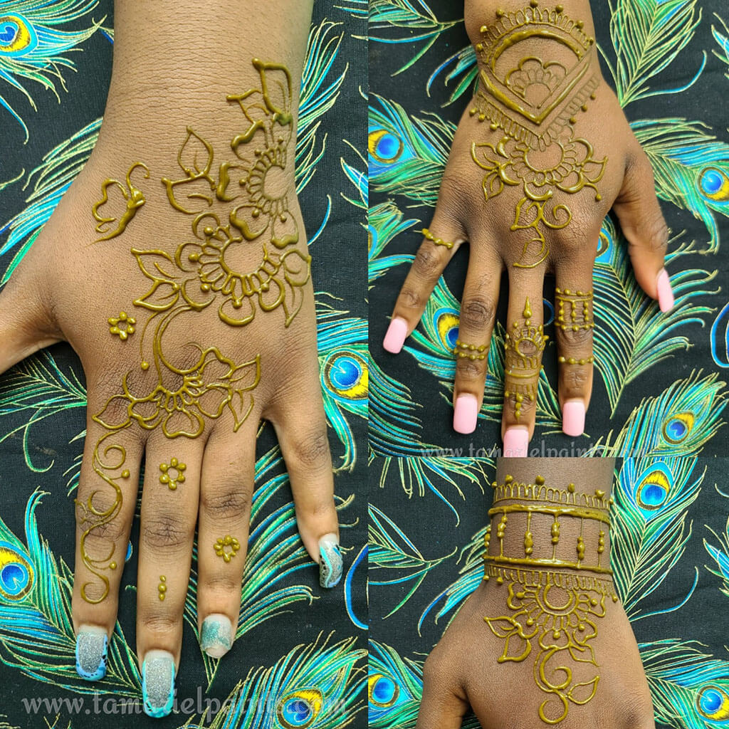 A hand with an intricate floral henna tattoo pattern