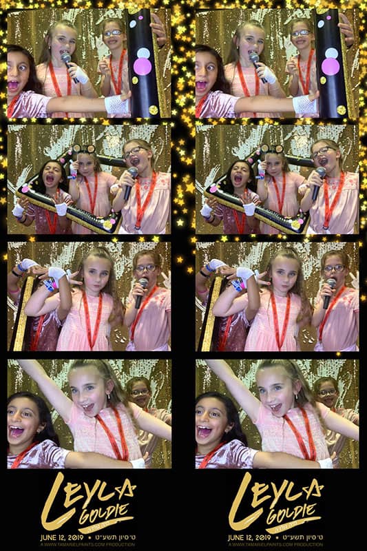 An example of kids having fun with a photo booth at a party