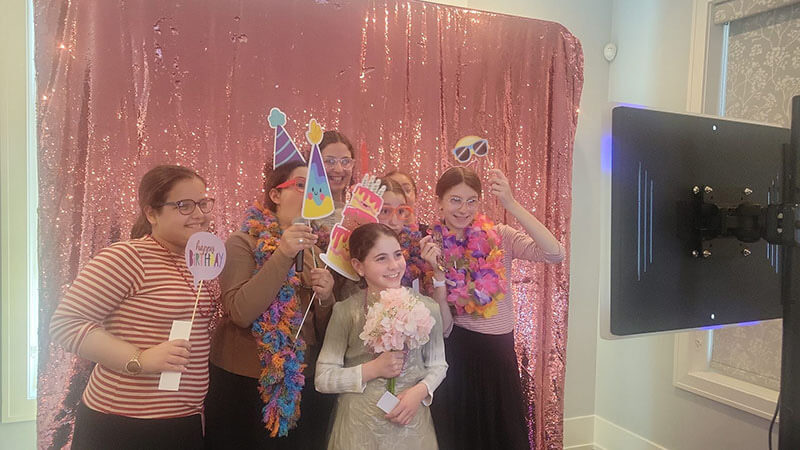 An example of people enjoying a photo booth at a birthday party