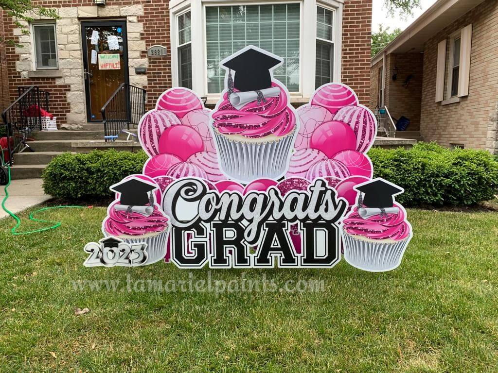 A photo of a custom made yard sign which reads Congrats Grad