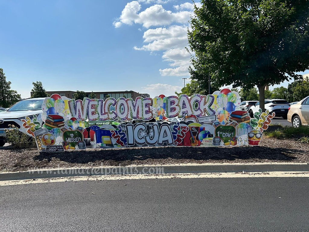 A photo of a custom made yard sign which reads Welcome Back Icja