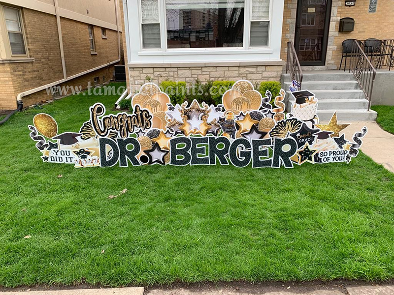 A photo of a custom made yard sign which reads Congrats Dr. Berger