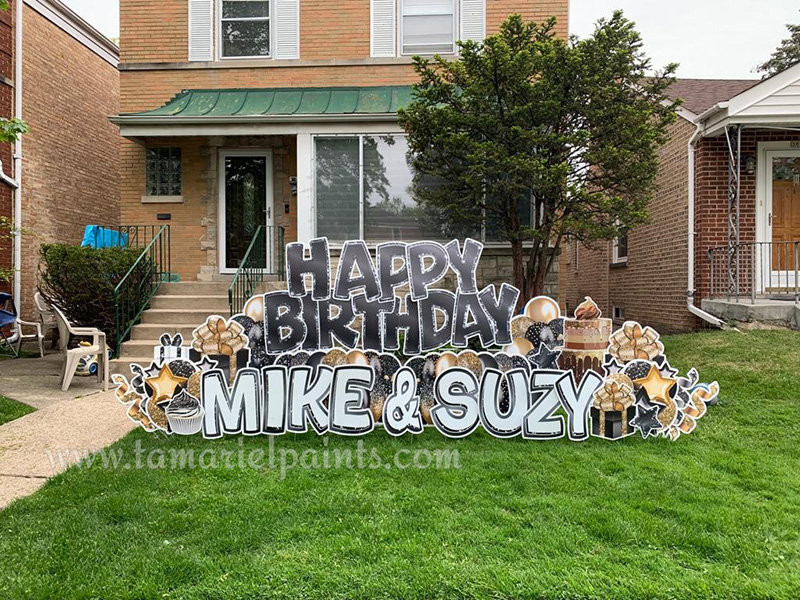 A photo of a custom made yard sign which reads Happy Birthday Mike and Suzy