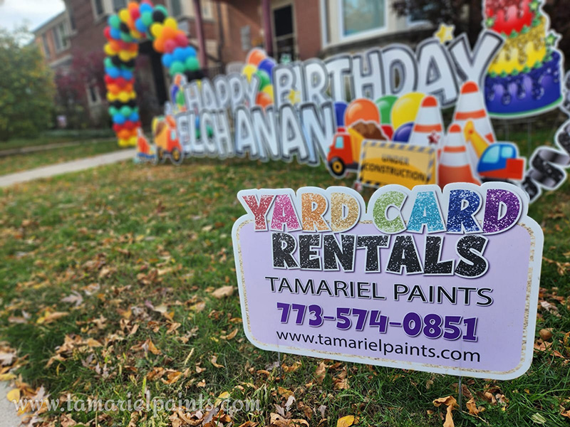 A photo with a Tamariel Paints promotional yard sign