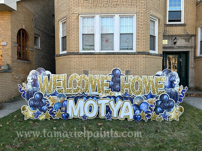 A photo of a custom made yard sign which reads Welcome Home Motya